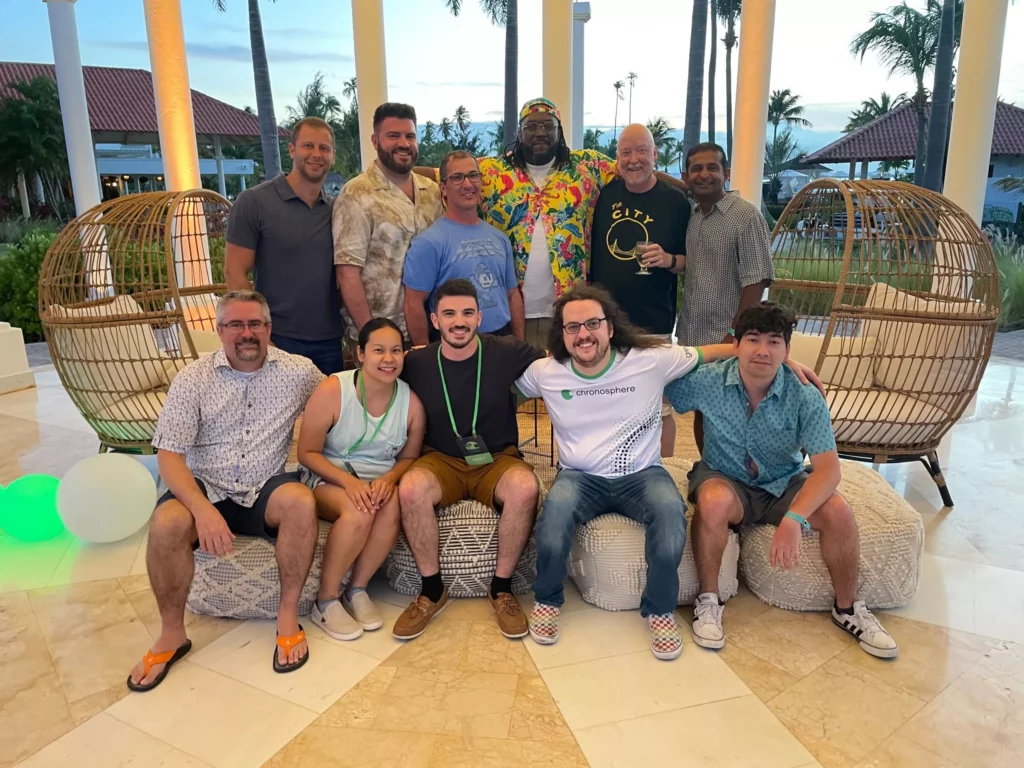 Chronosphere team members posing for picture outdoors in warm, tropical area