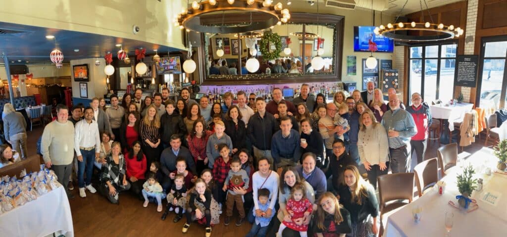 Triverus team and family at restaurant taking group photo