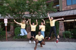 givebutter team jumping in air